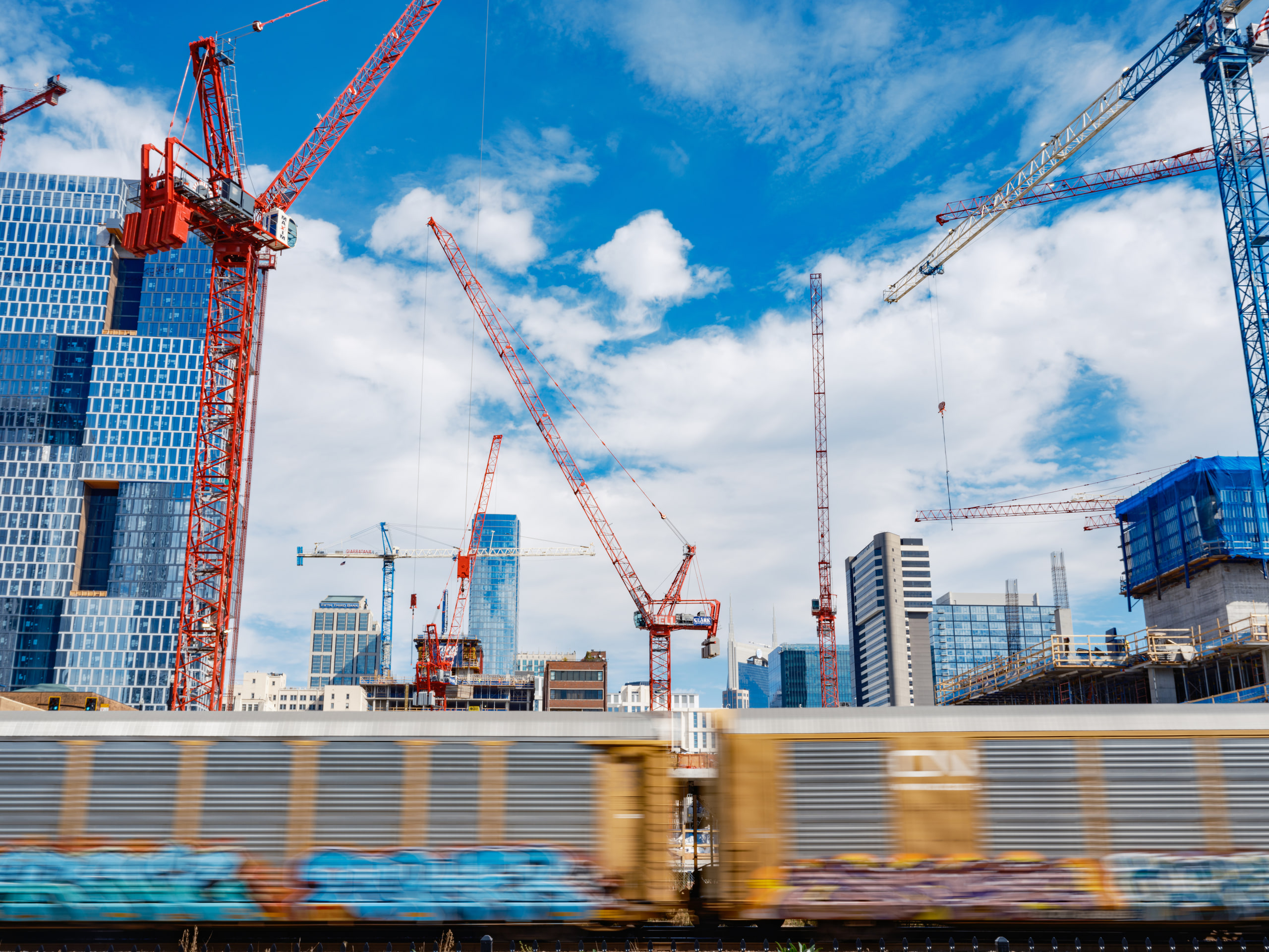 Cranes and cloud, color and diagonal.