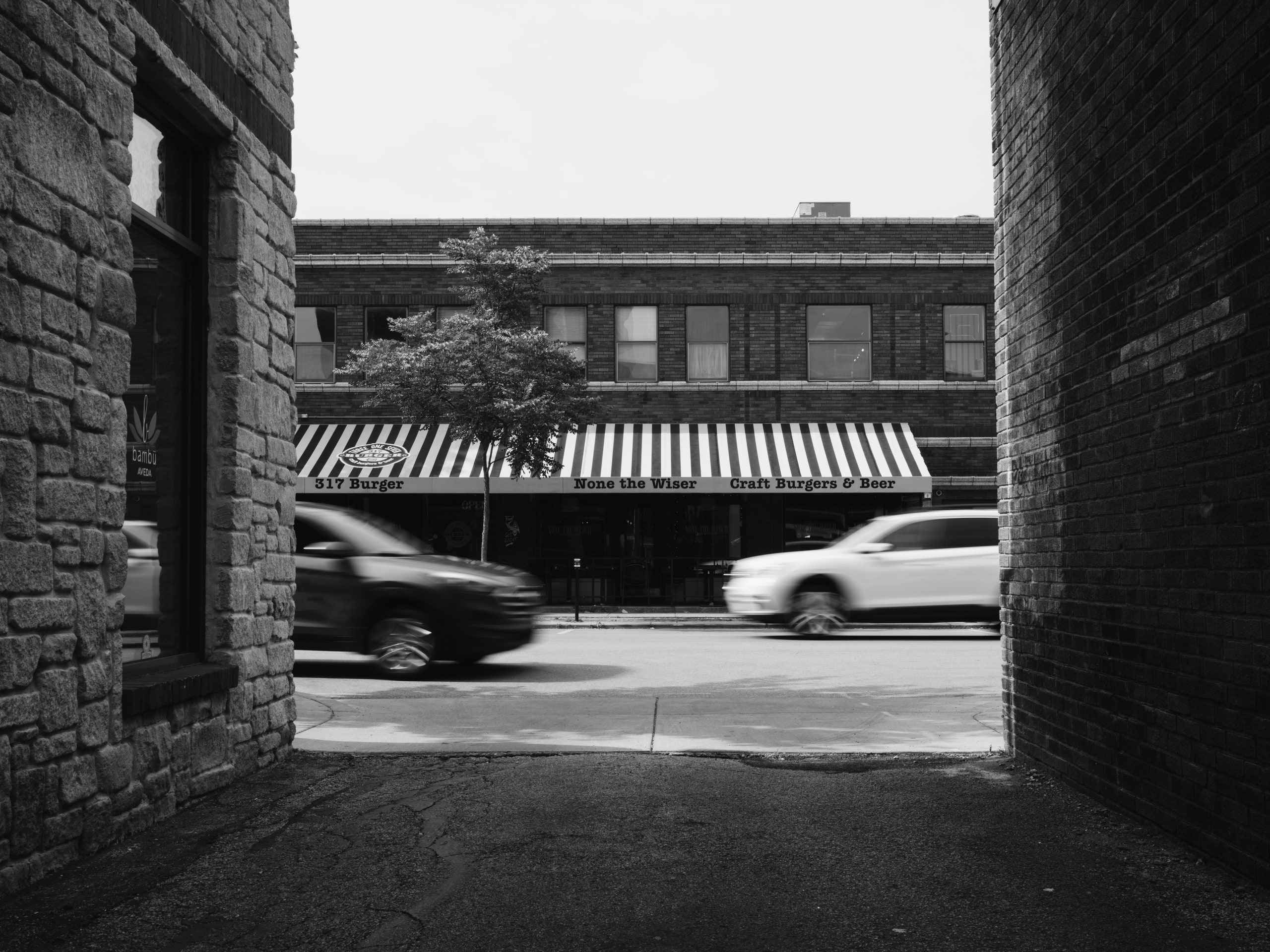 B&w storefront, street geometry.