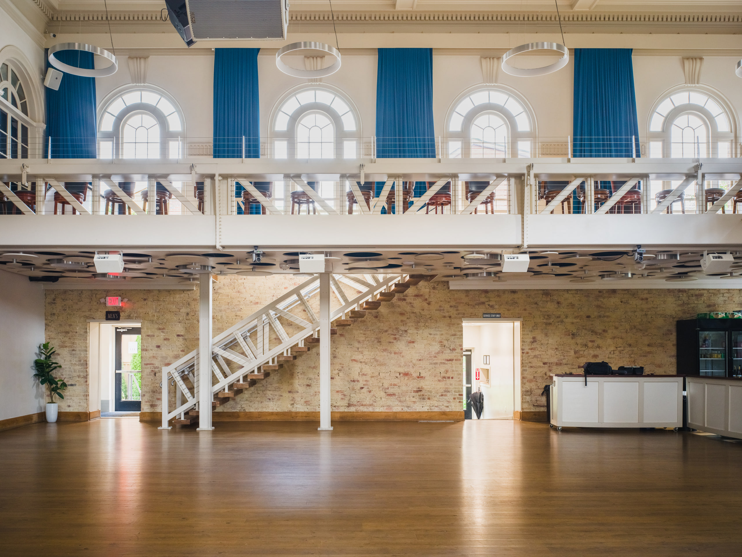 Staircase wide, the room empty and honest.