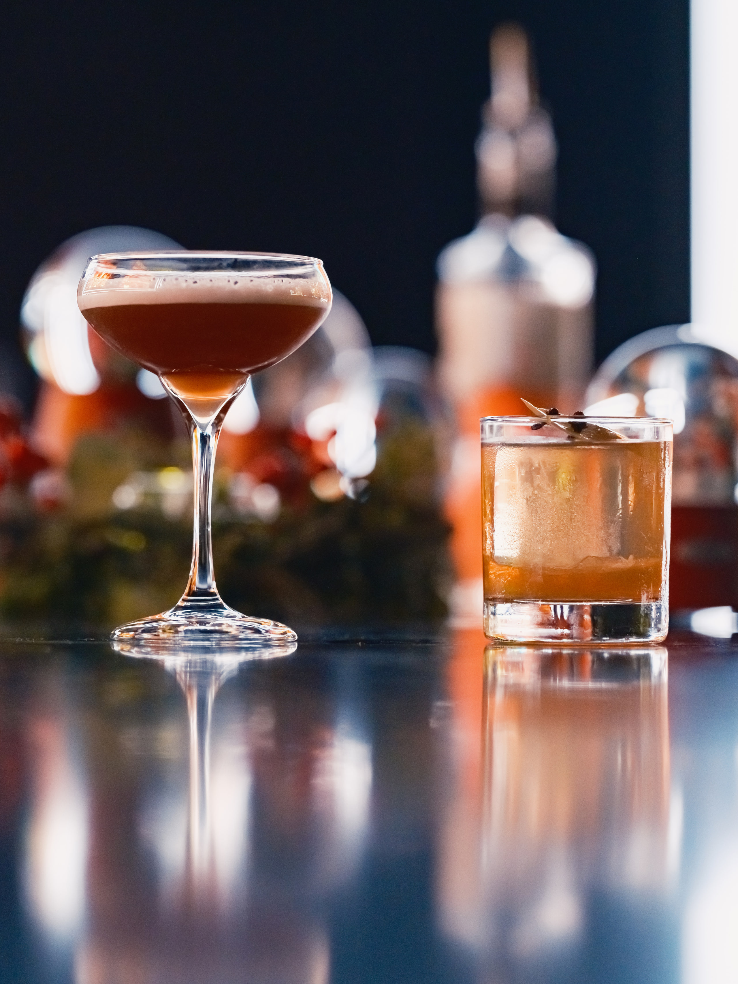 Cocktail and snow globes, styled still life.