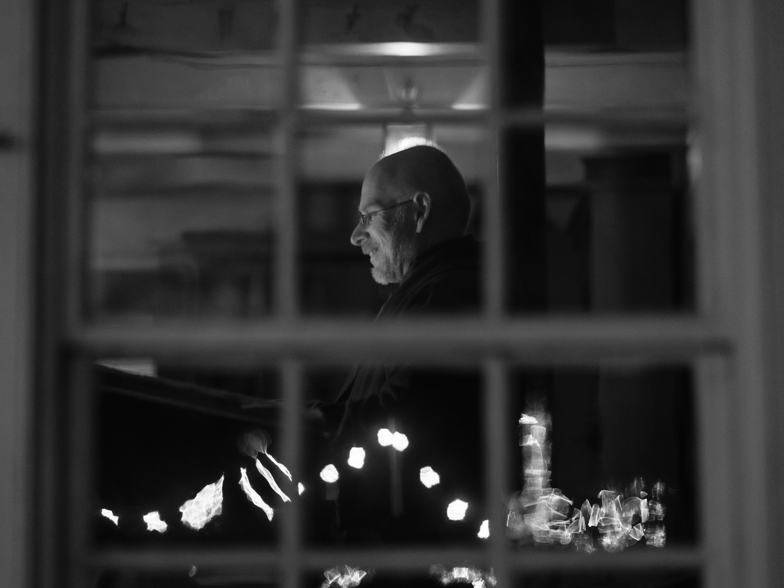 B&w window with lights beyond.