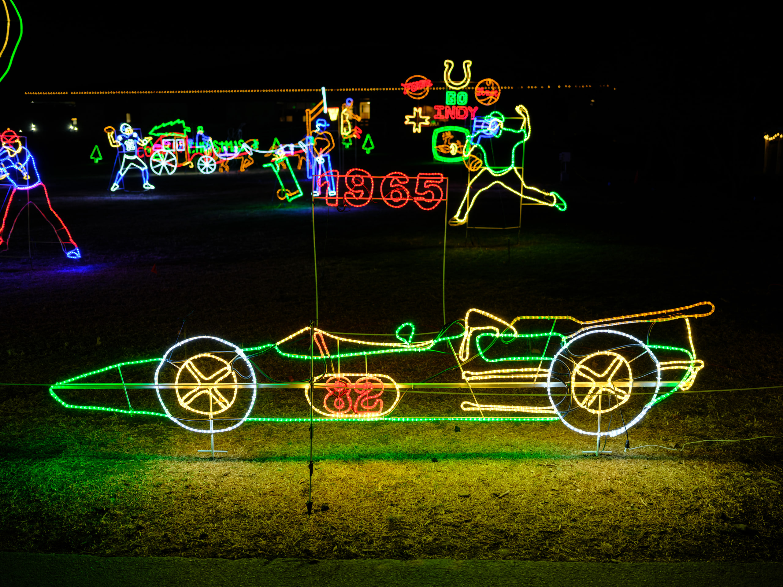 Light sculpture car, neon line on black.