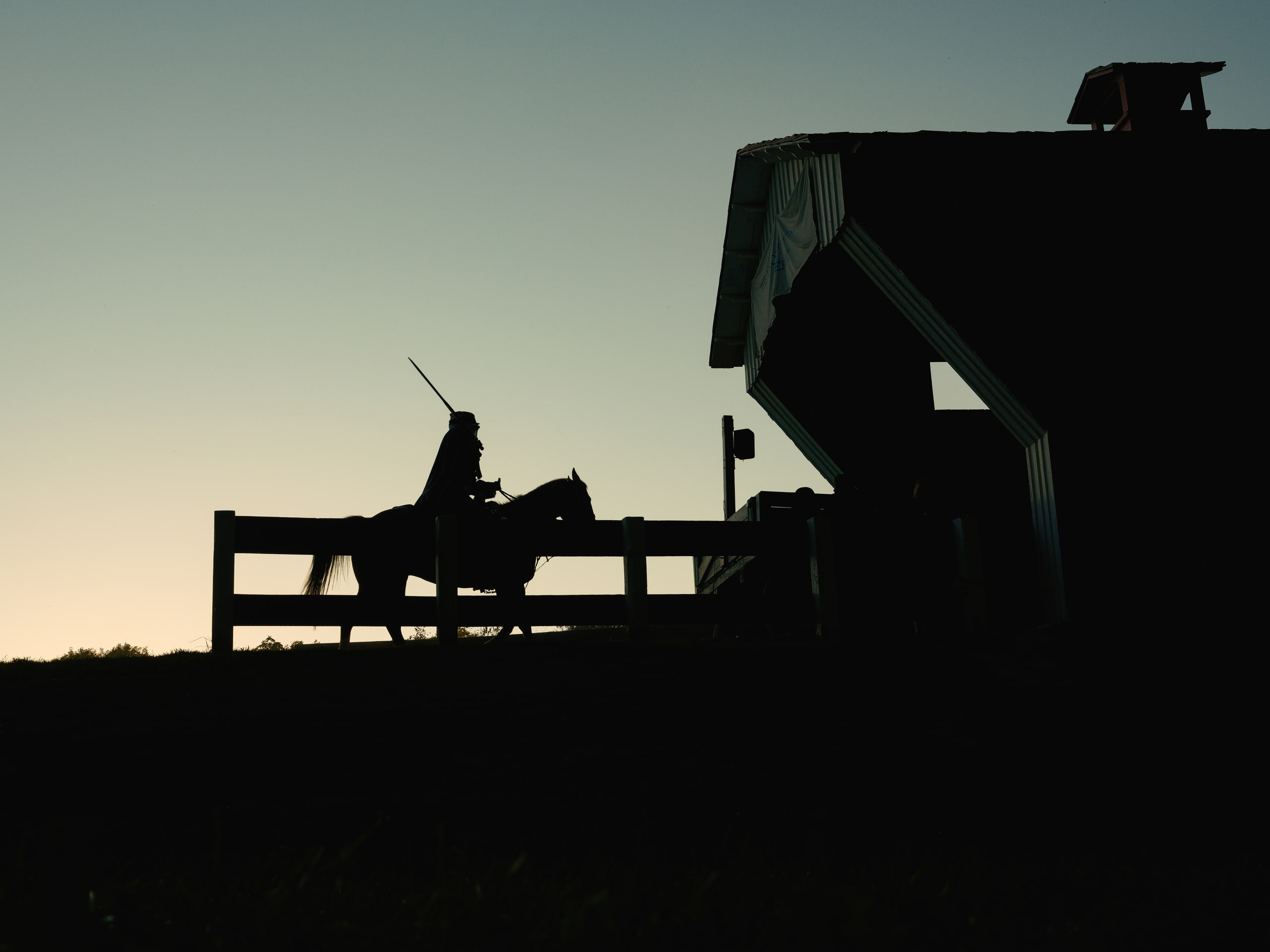 Wagon in silhouette against sunset, pure shape.