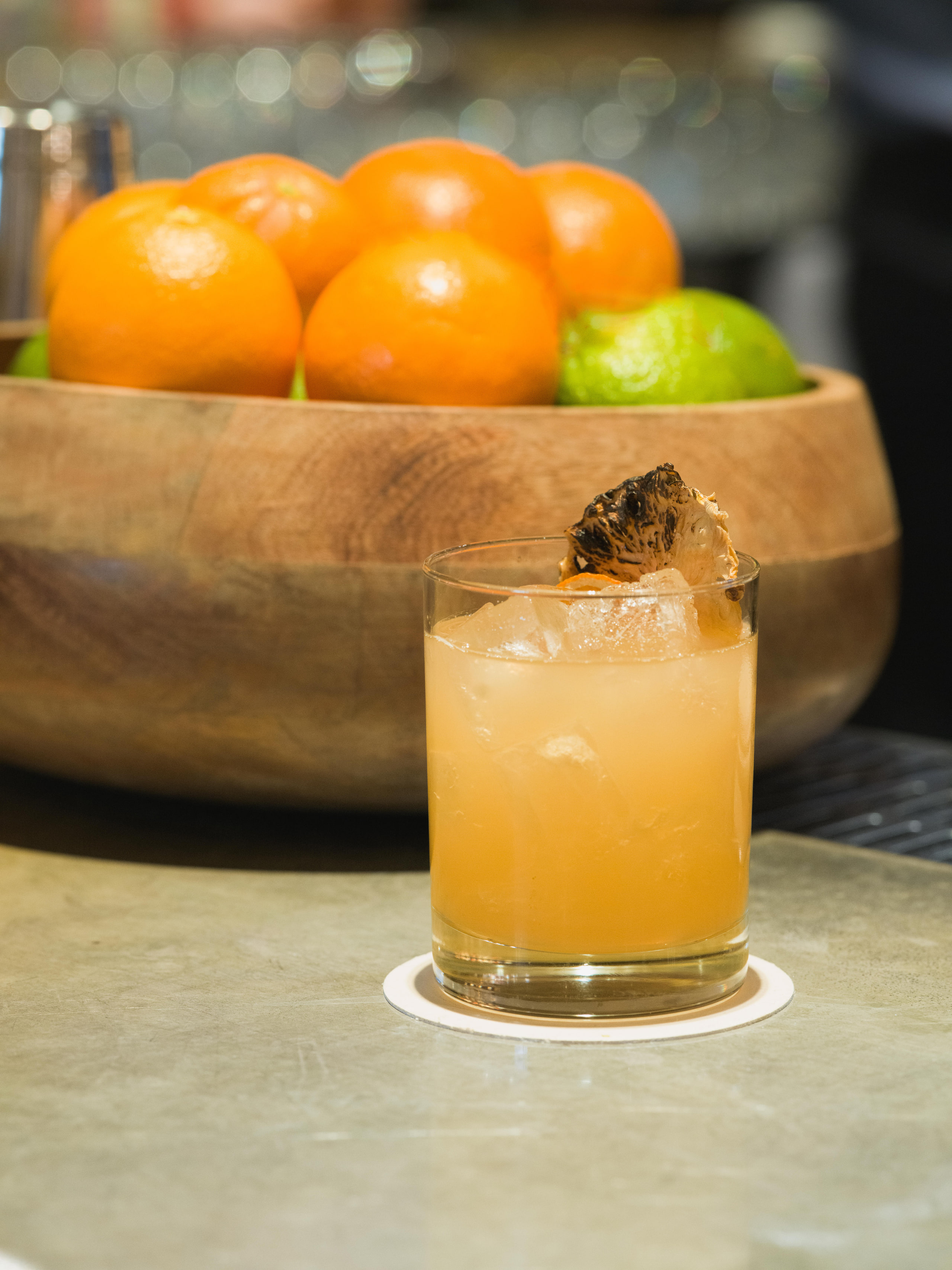 Citrus cocktail, warm against dark.