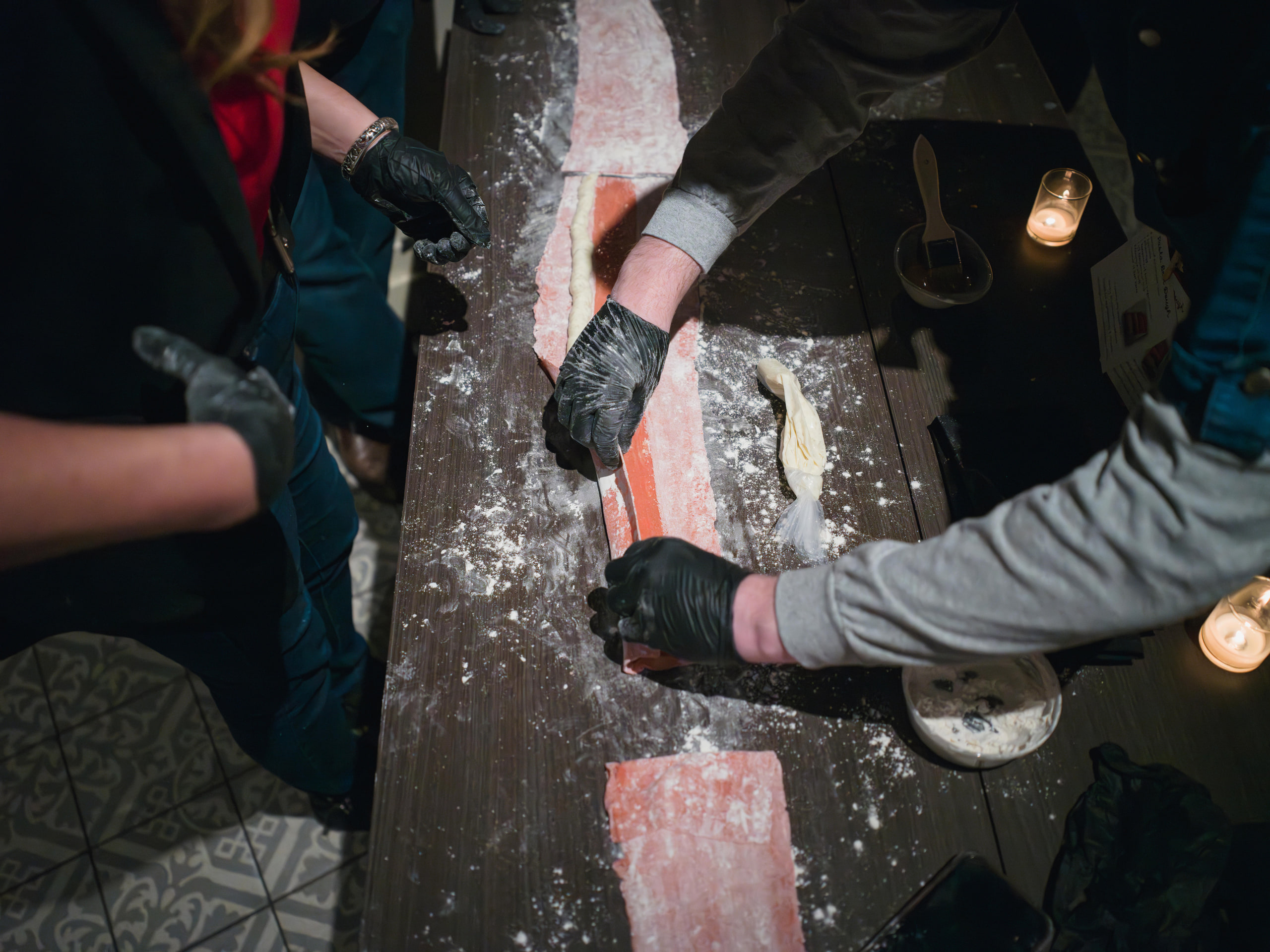 Flour and hands, dust in the light.