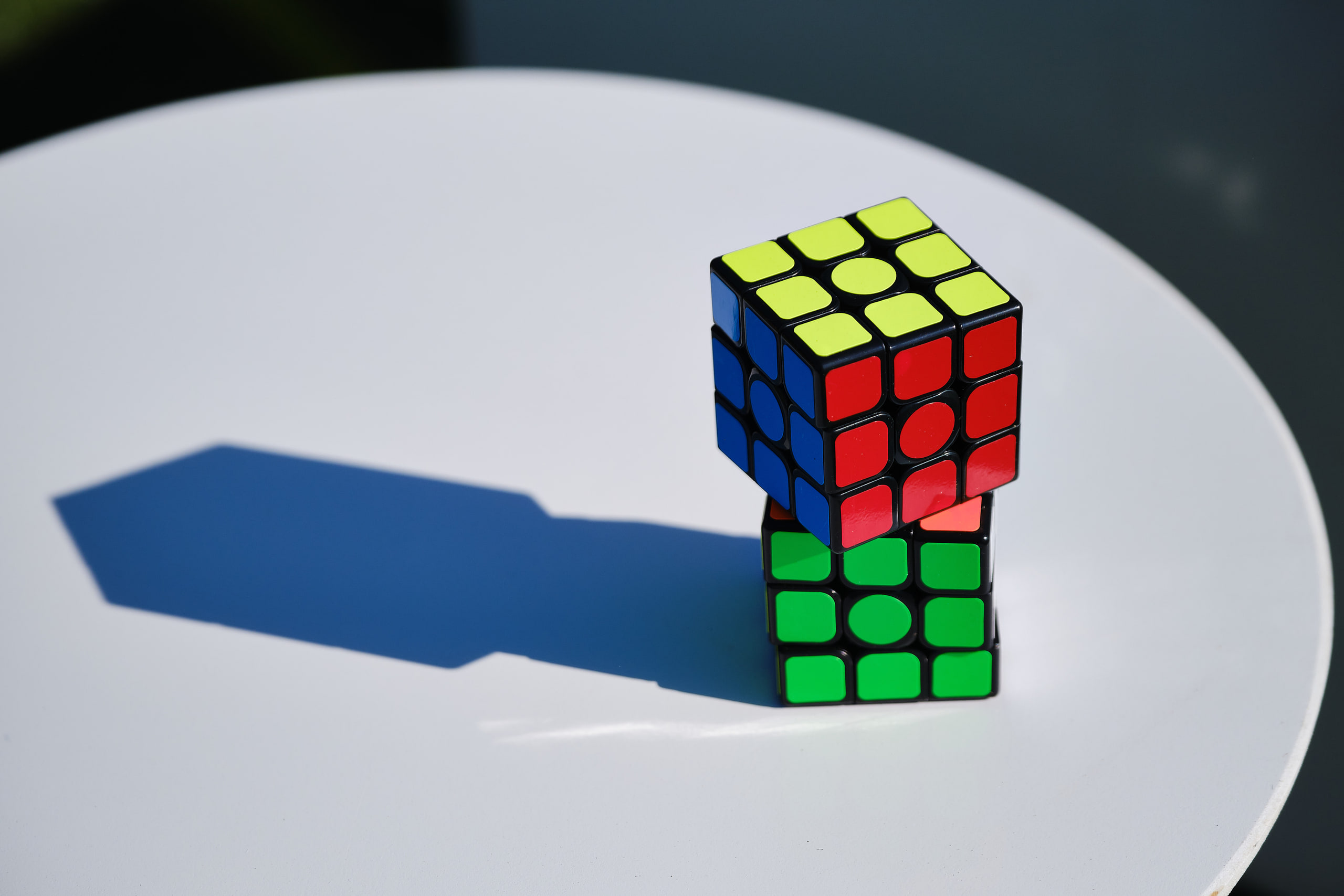 Rubik cube on white, negative space.