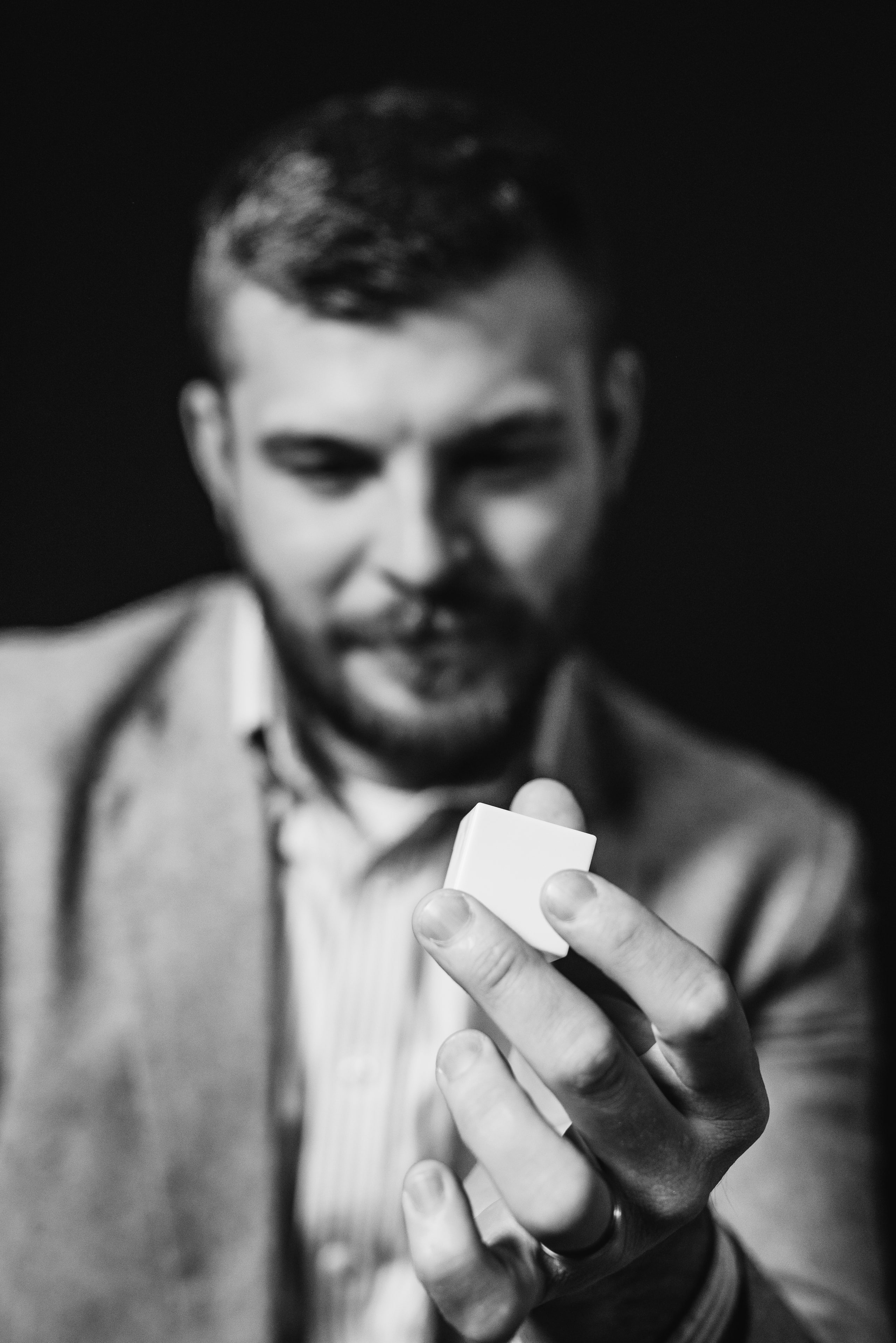 B&w, presenting the product, hands and face.