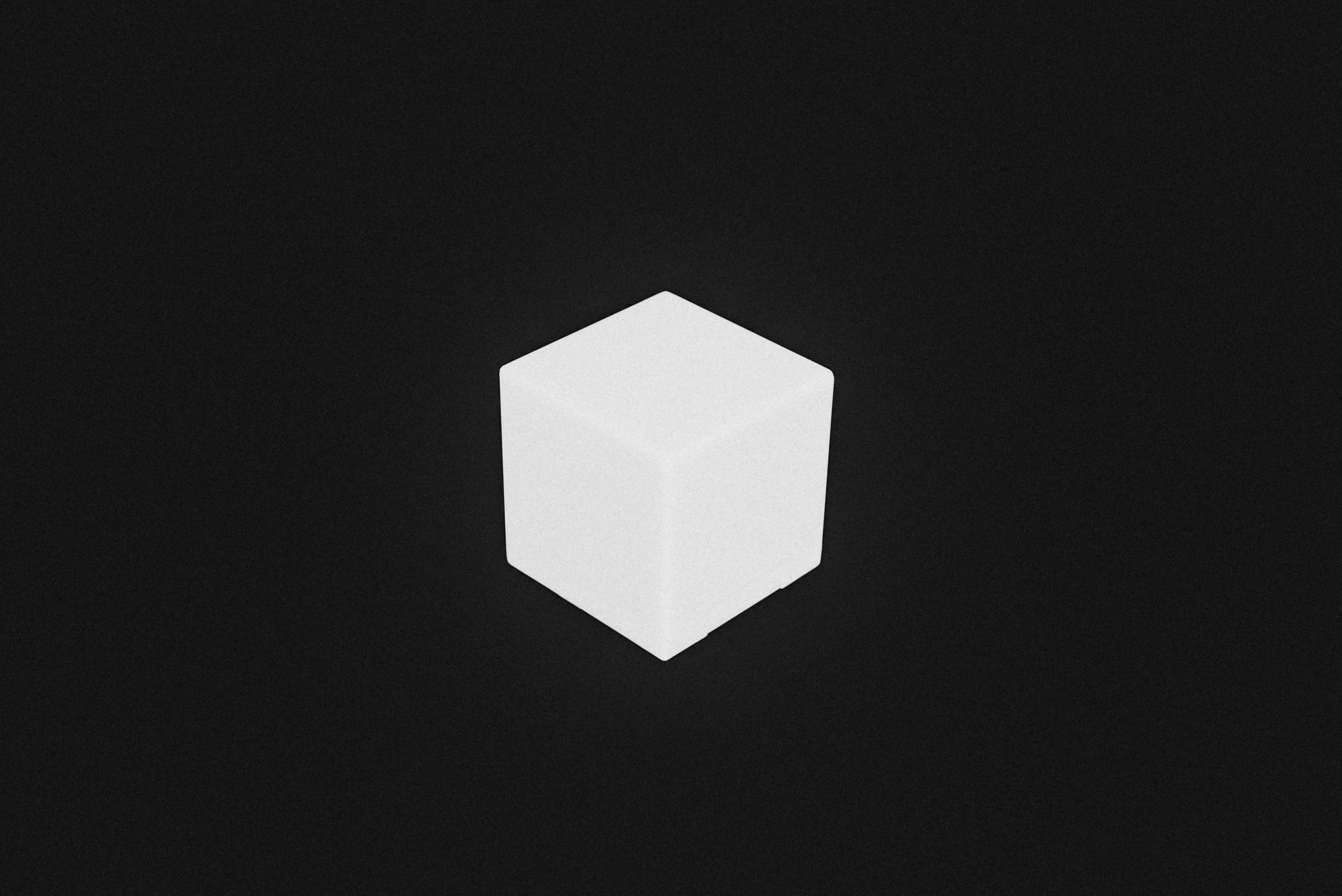 Cube on black, geometry and shadow.