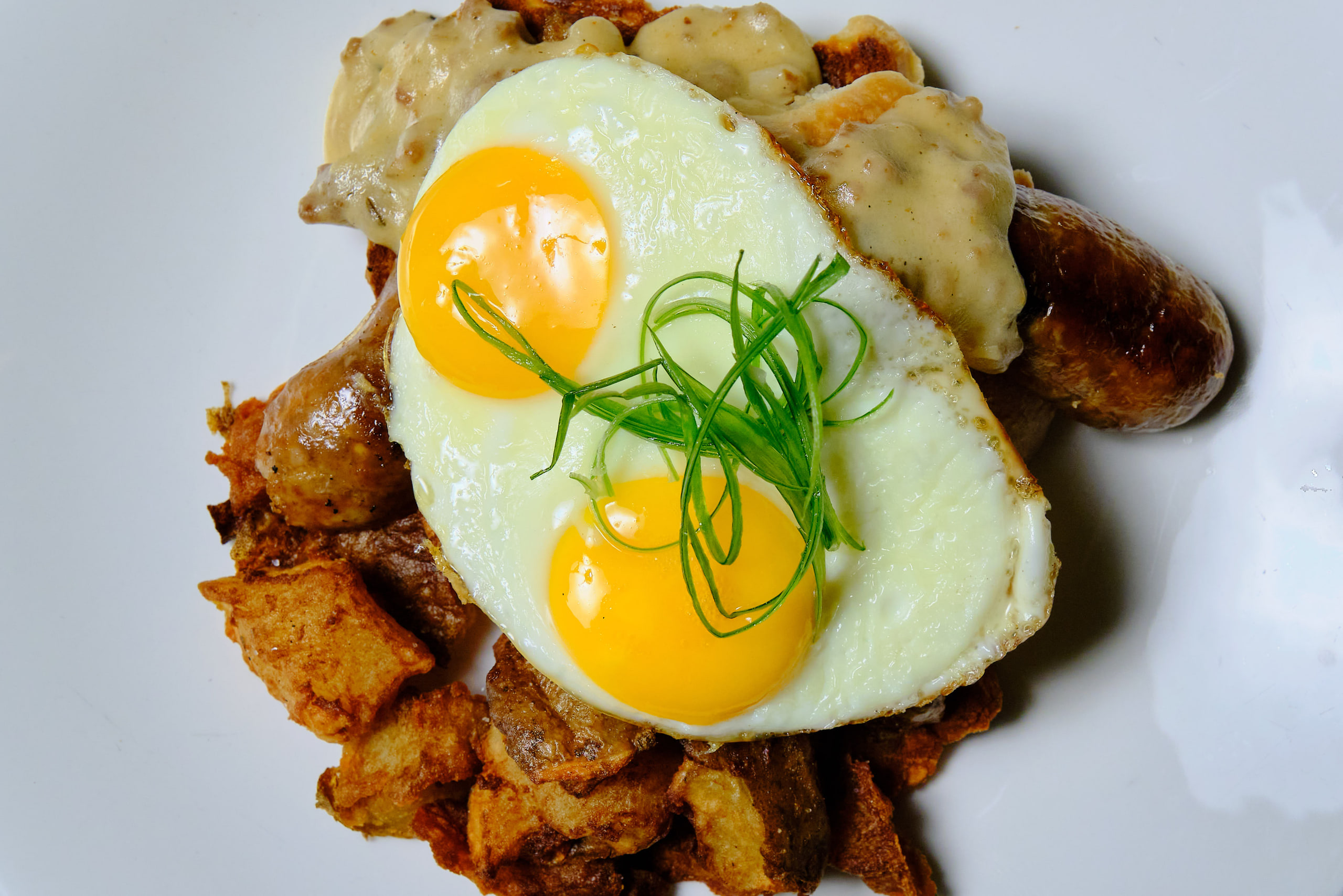Fried egg over hash, warm, classic.