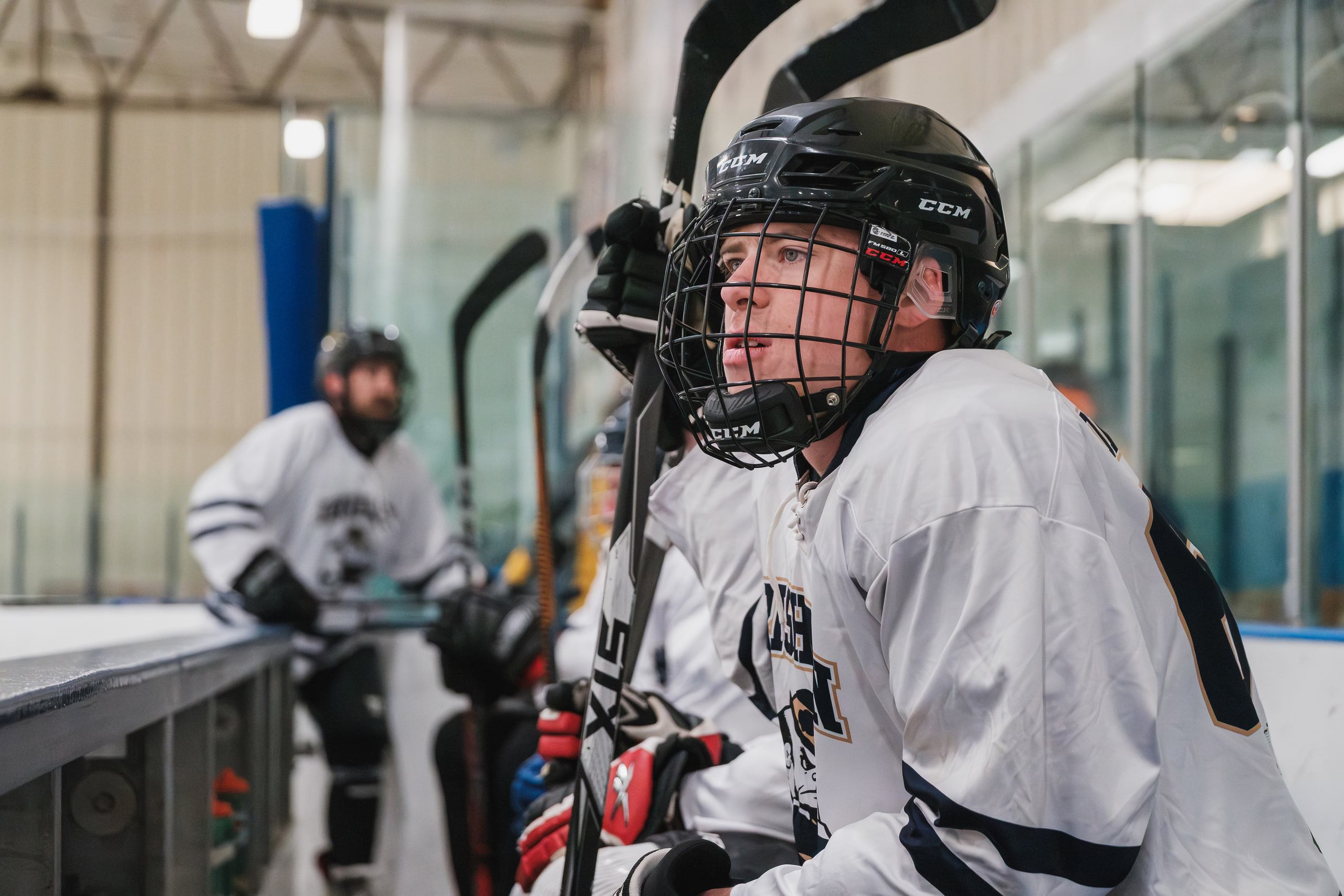 Smiling through the cage, team behind him.