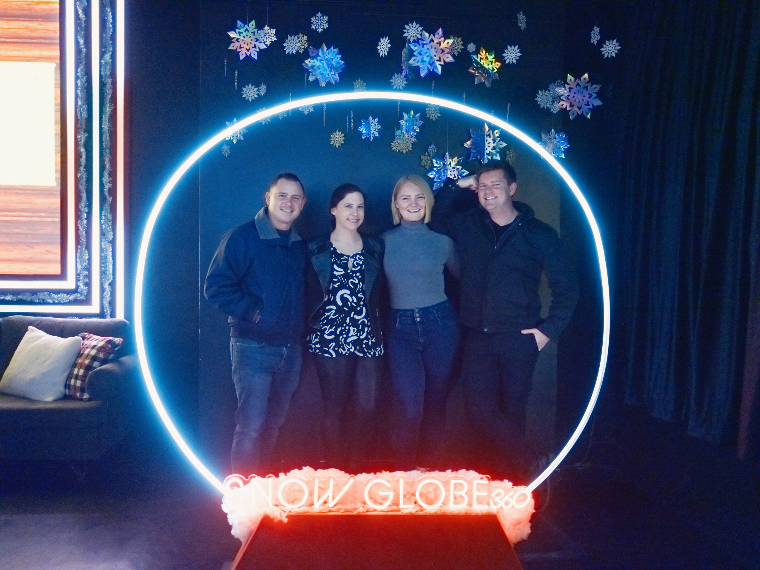 Couple inside a lit neon ring, framed by the light.