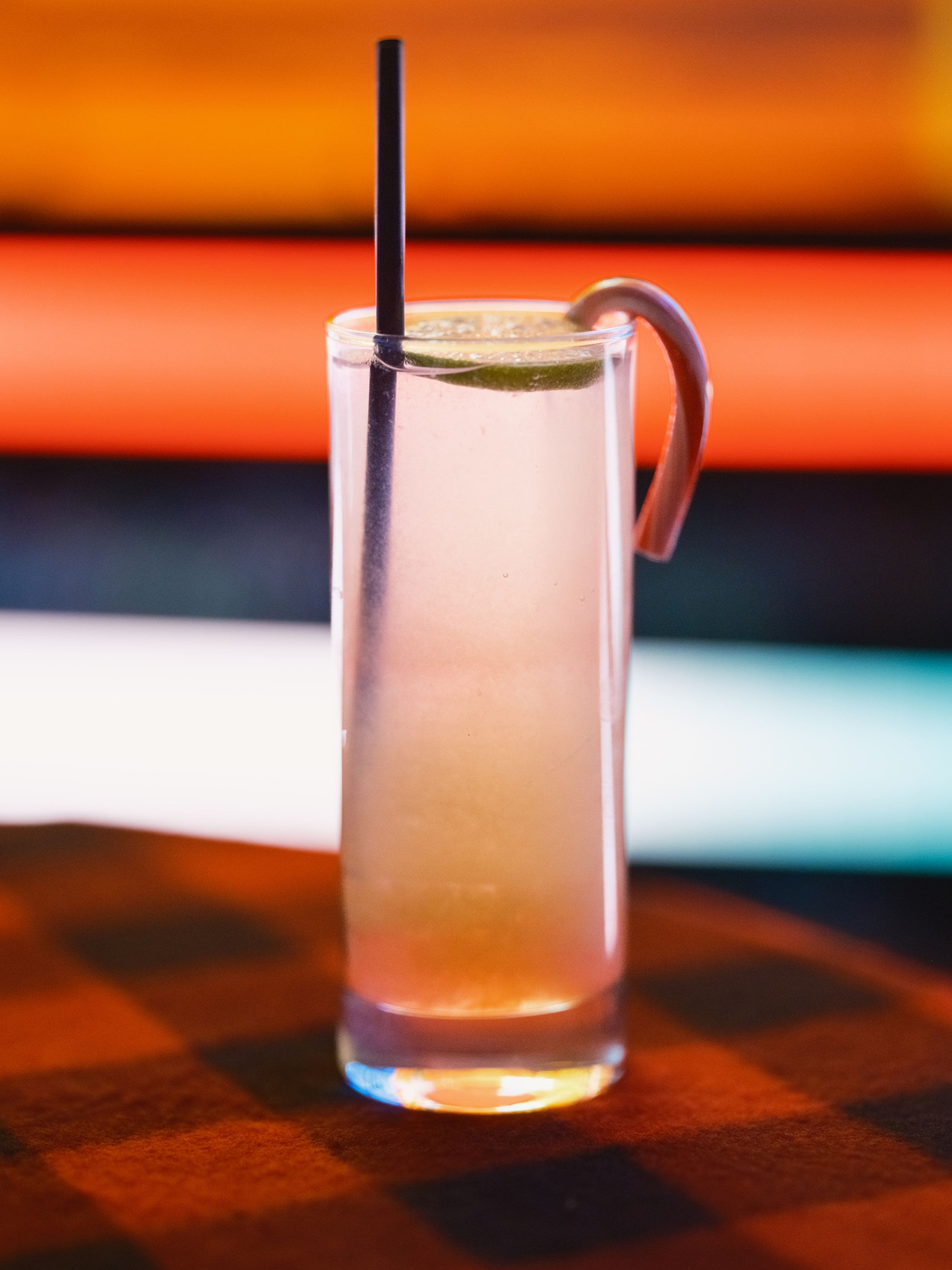 Drink against orange neon, contrast.