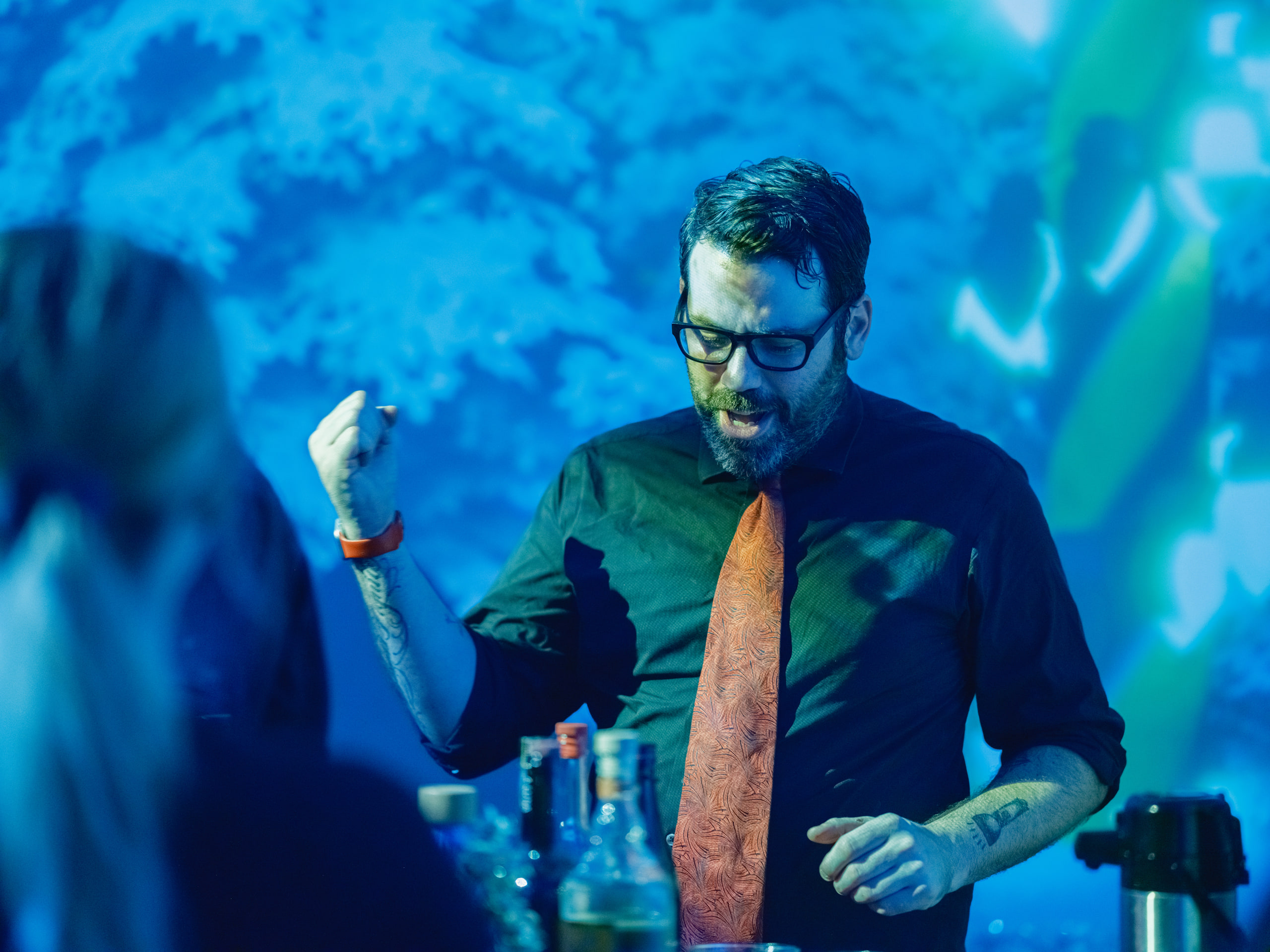 A man against blue light, clear subject.