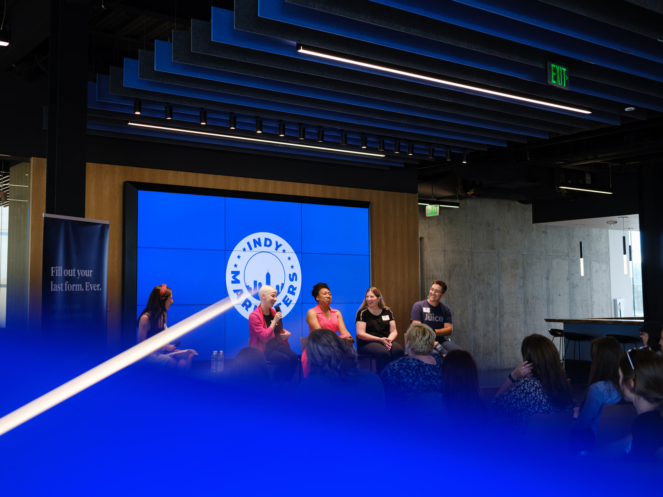Blue room, audience as silhouette.