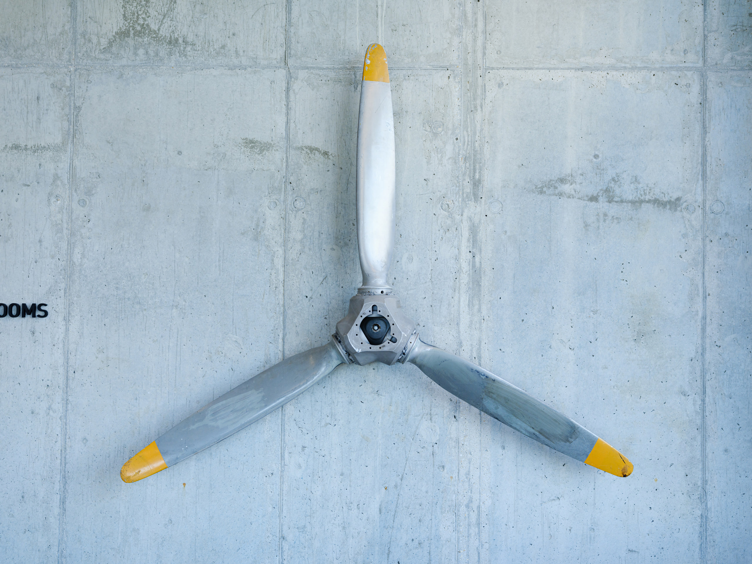 Propeller on concrete, negative space.